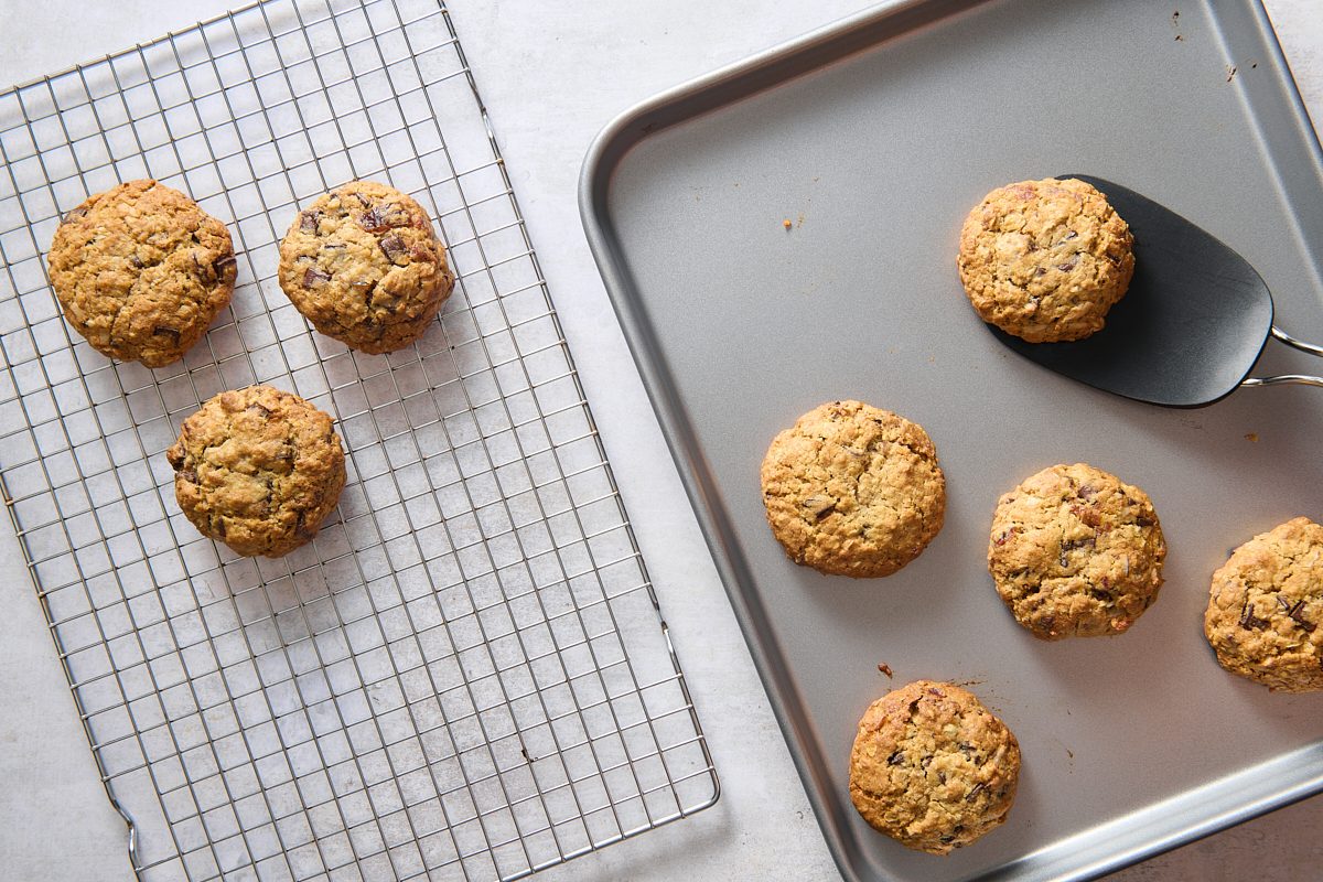 Baked breakfast cookies being transferred to a cooling rack