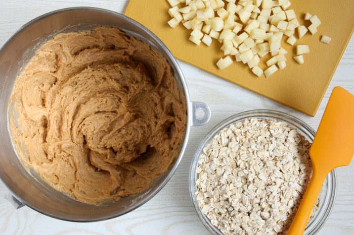 Adding apples and oats to cookie dough