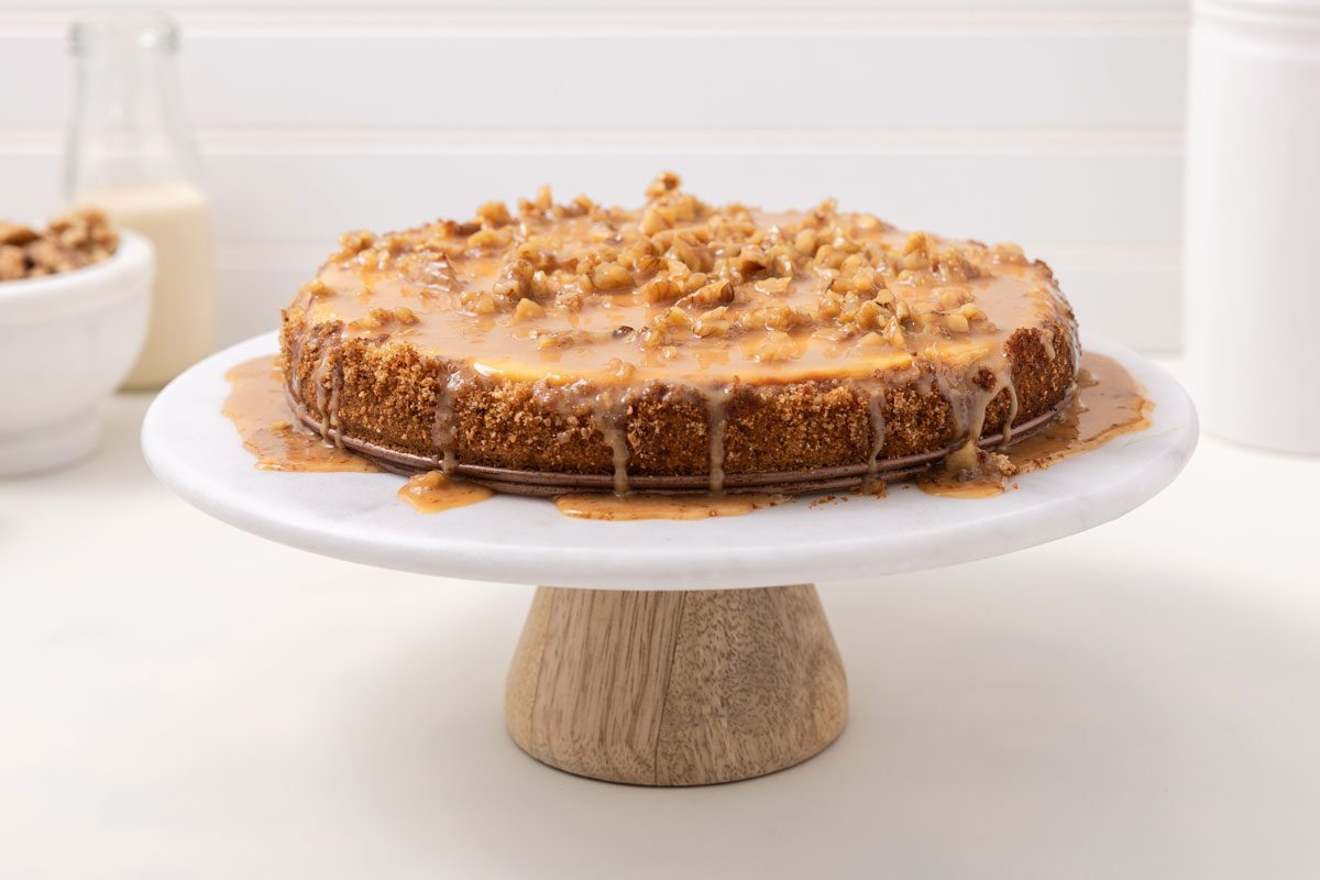 Cheesecake Ready With Caramel Sauce On Top On Cake Stand.