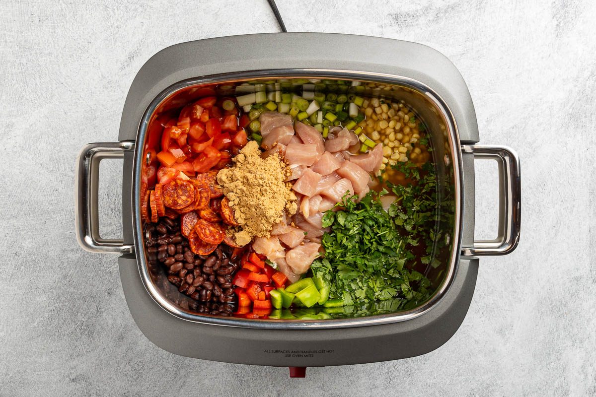 Taste of Home Chicken Fajita Soup recipe photo of all the ingredients, except the nacho cheese condensed soup and avocado, are combined in a slow cooker.