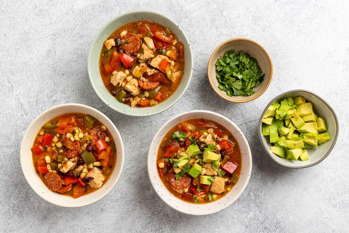 Taste of Home Chicken Fajita Soup recipe photo of soup served into bowls with avocado and cilantro to garnish.