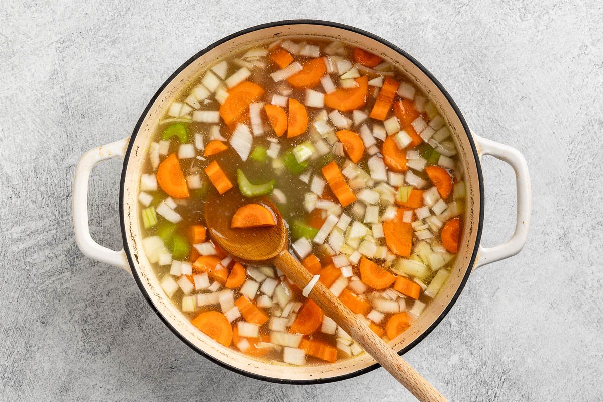 Taste of Home Chicken and Rice Soup recipe photo of the rice and vegetables added to the dutch oven.