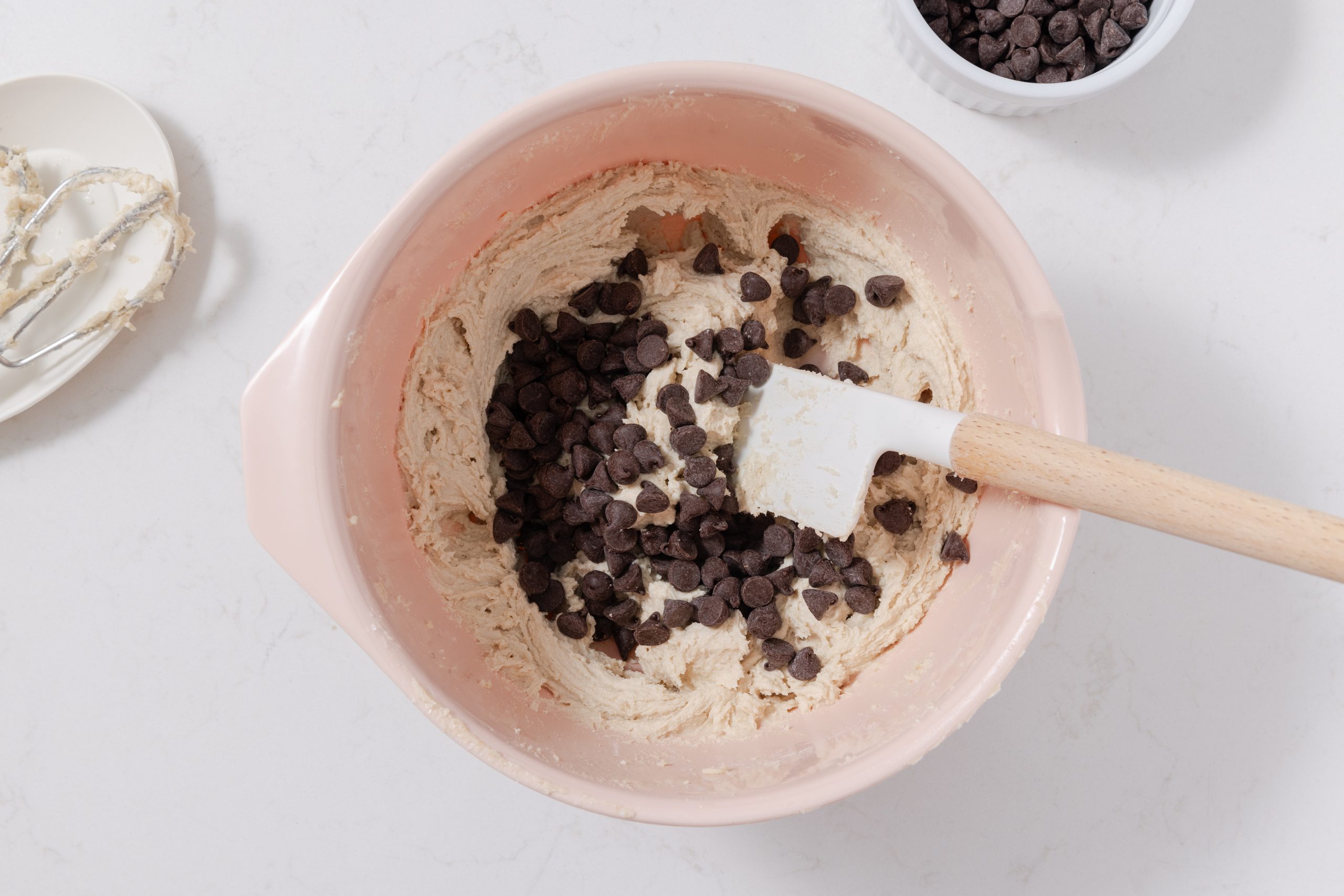 Cookie dough being prepared in mixing bowl.