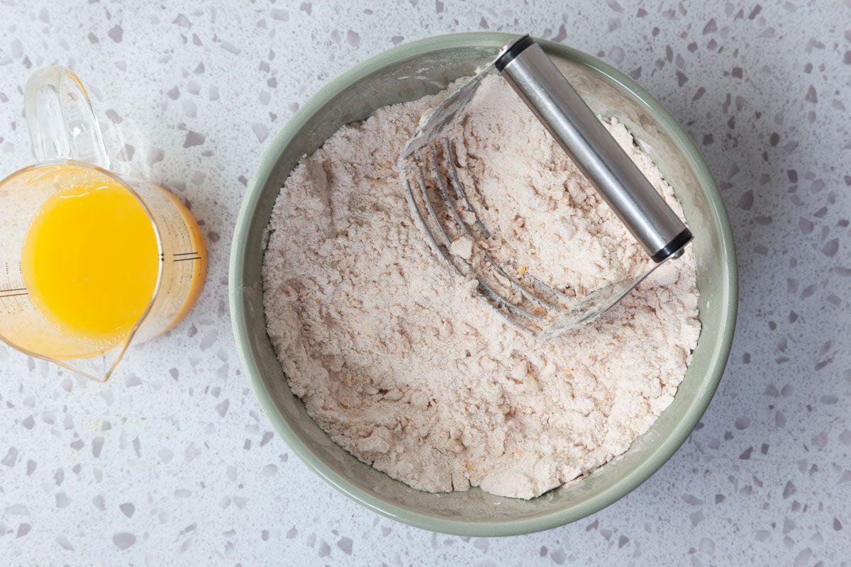 Step 2 of Taste of Home Cranberry Muffins is to cut the shortening into the flour mixture until it resembles course crumbs