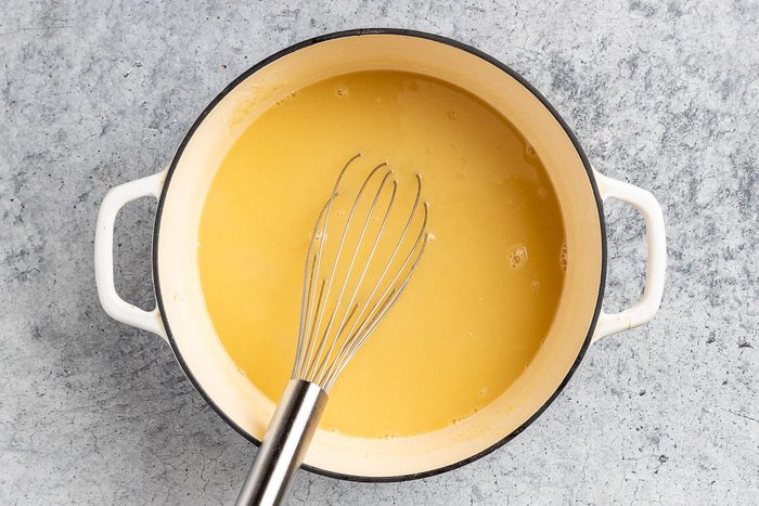 Taste of Home Dill Pickle Soup recipe photo of making the soup base with butter, onion, garlic, flour, white wine and chicken stock.