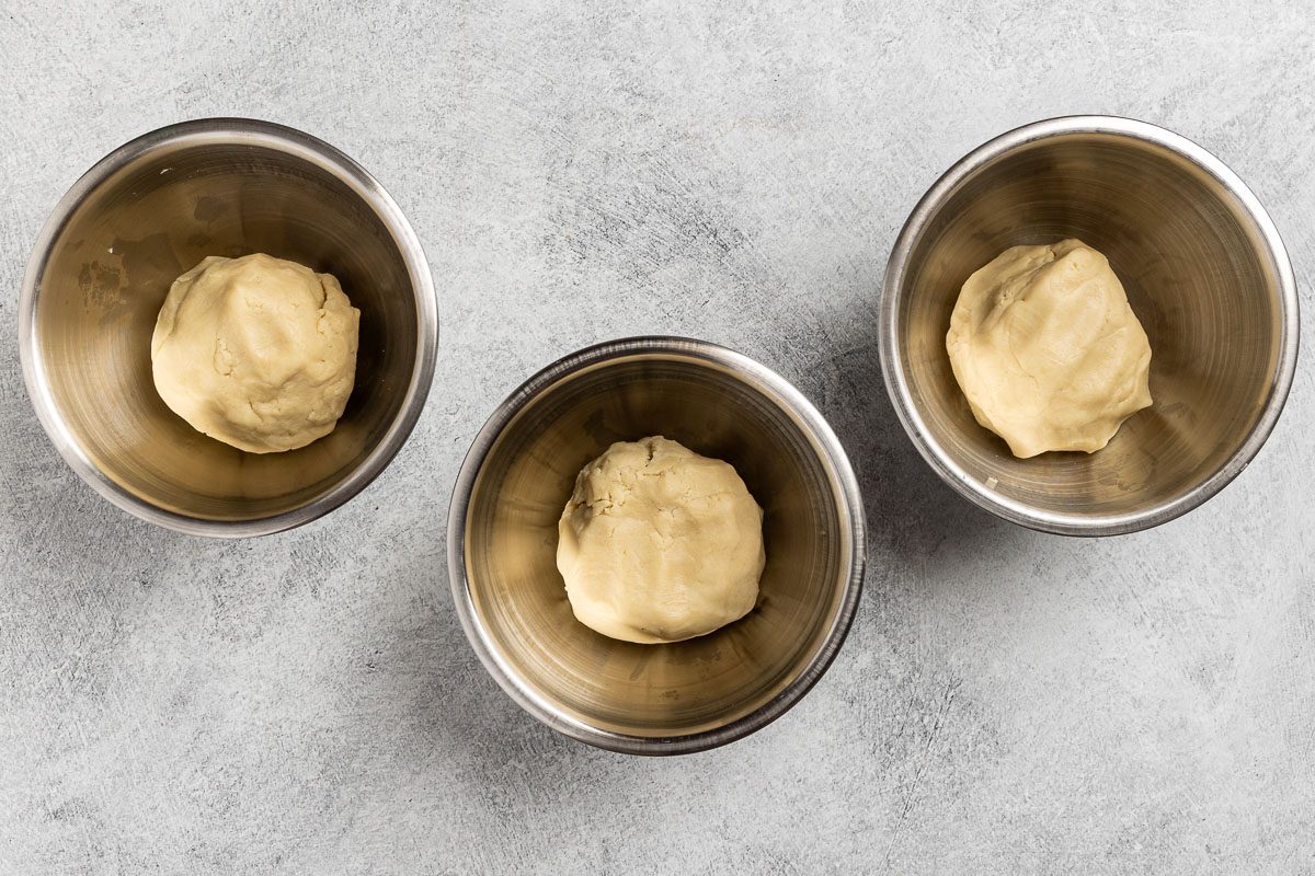 Taste of Home Italian Spumoni Cookies recipe photo of the cookie dough combined with flour and divided into three portions.