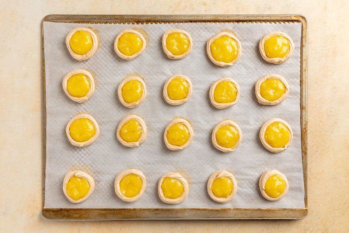 Taste of Home Lemon Meringue Cookies recipe photo of the lemon curd spooned into the center of the cookies.