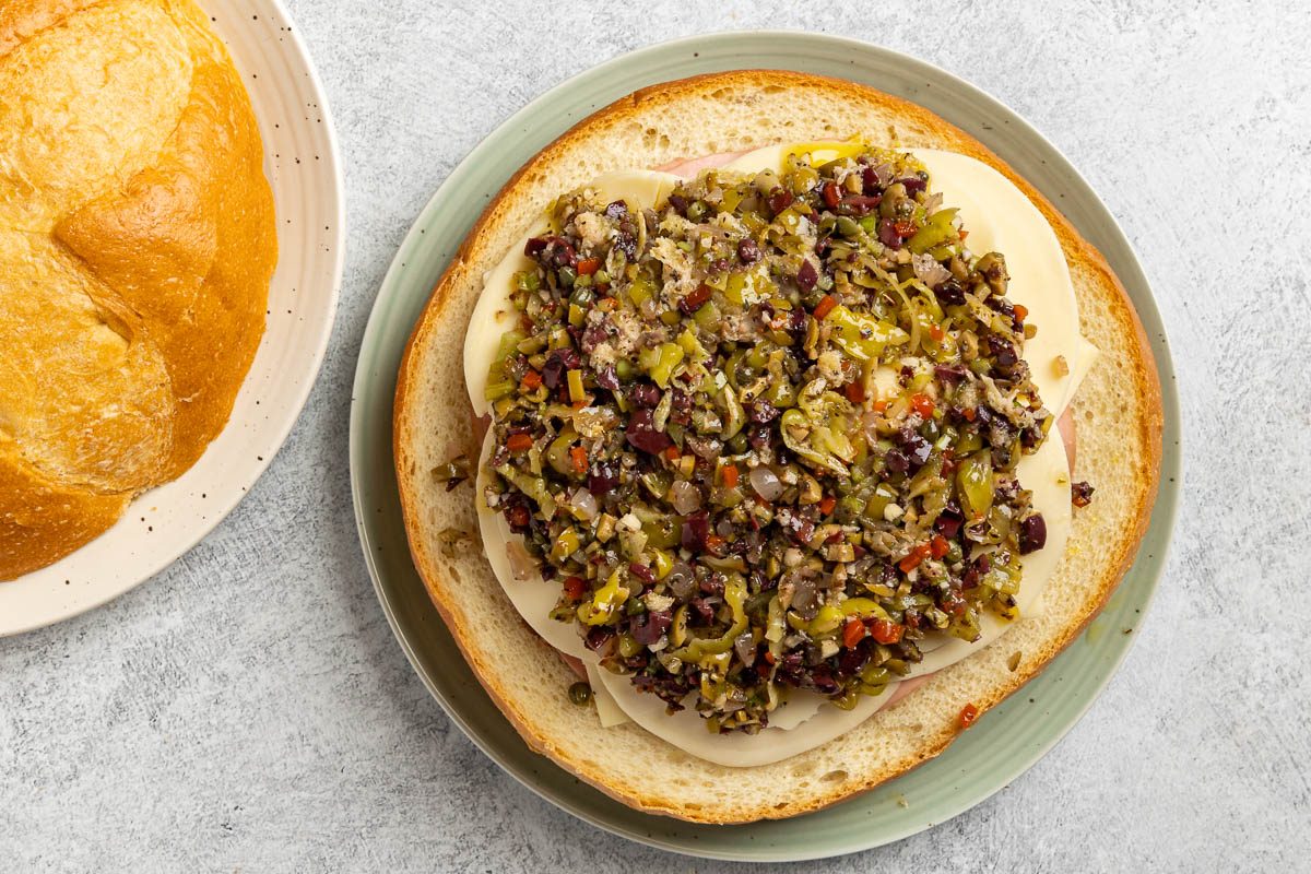 Taste Of Home Muffuletta Recipe Photo Of Assembling The Sandwich.