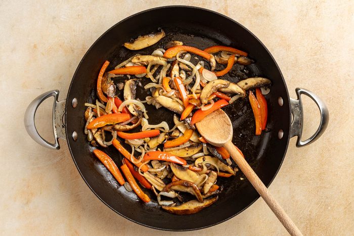 Taste of Home Mushroom Tacos recipe photo of the mushrooms, red pepper, and onion sauteed in a skillet.