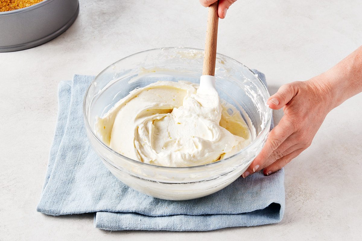 No Bake Lemon Cheesecake Step 3- folding whipped cream into filling mixture