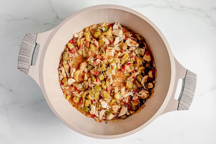Taste of Home okra gumbo in a Dutch oven on a marble surface.