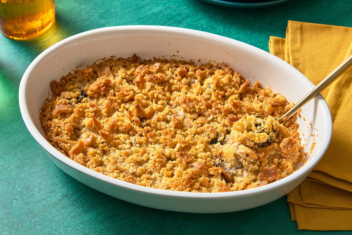 Oyster casserole being scooped out of a baking dish