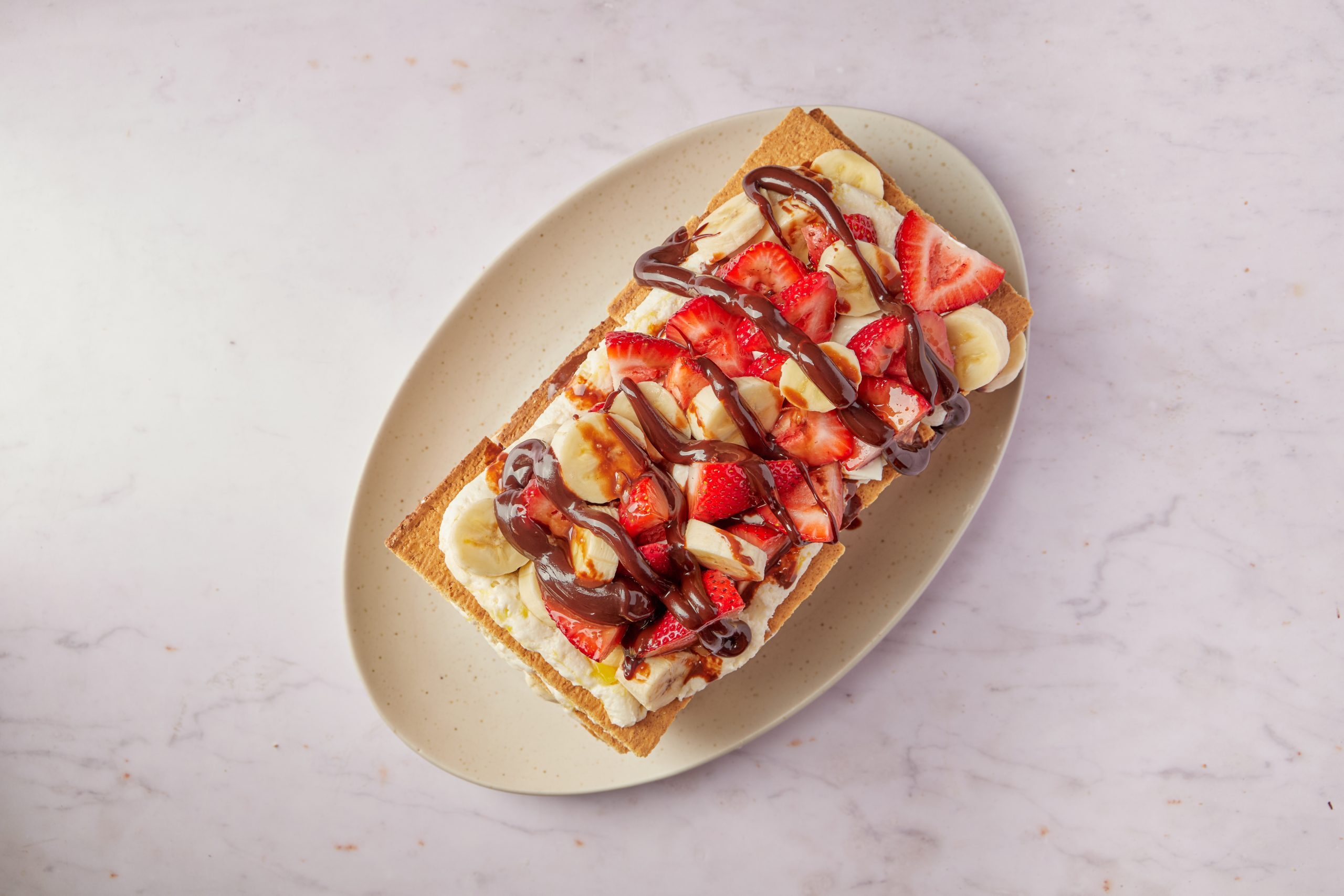 This banana split cake takes a twist on the beloved ice cream dessert with a timeless no-bake recipe.