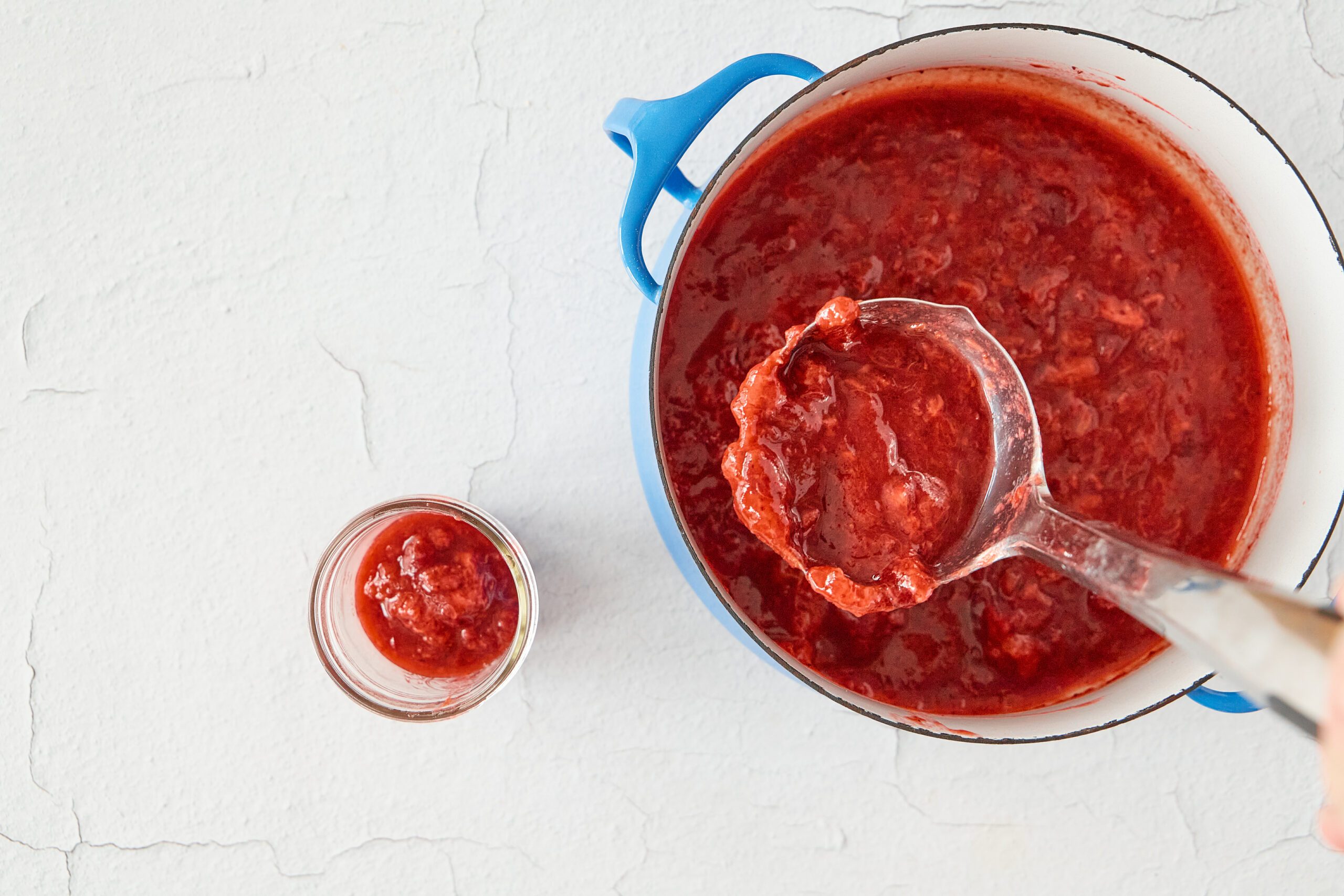 Put the strawberry rhubarb jam into jars.