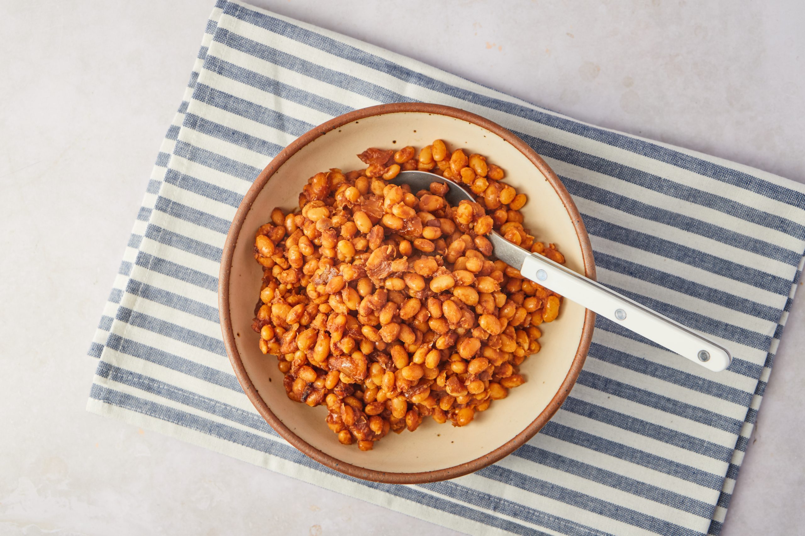 You won't miss the bacon in these vegan baked beans! Slow-cooked beans and warm spices create a rich sauce that everyone at the party will love.
