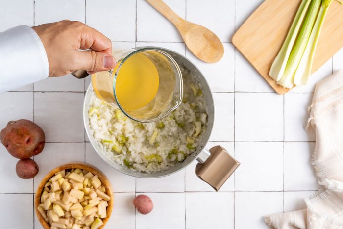cooking potatoes, onions and broth