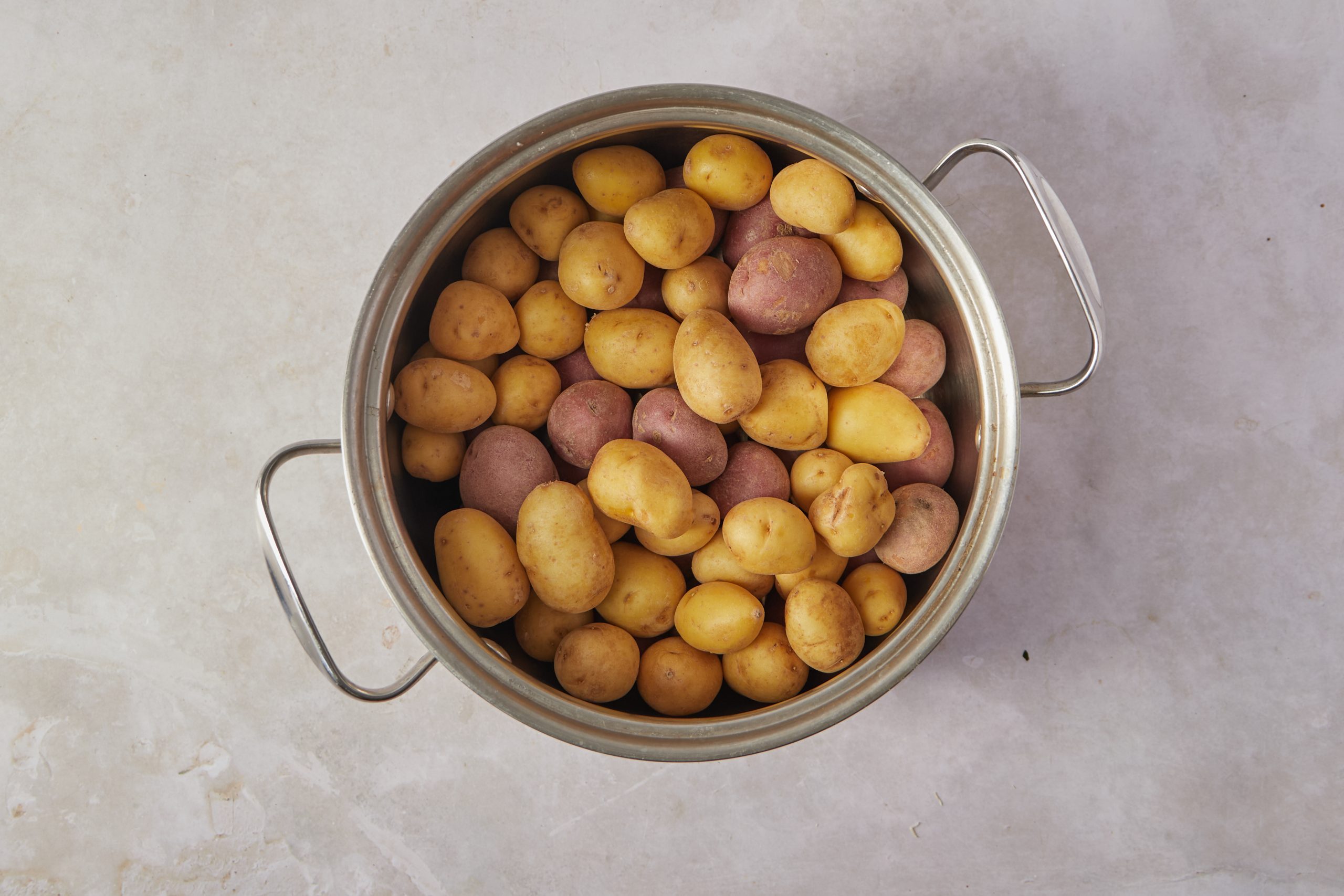 Cook the potatoes for the French potato salad.