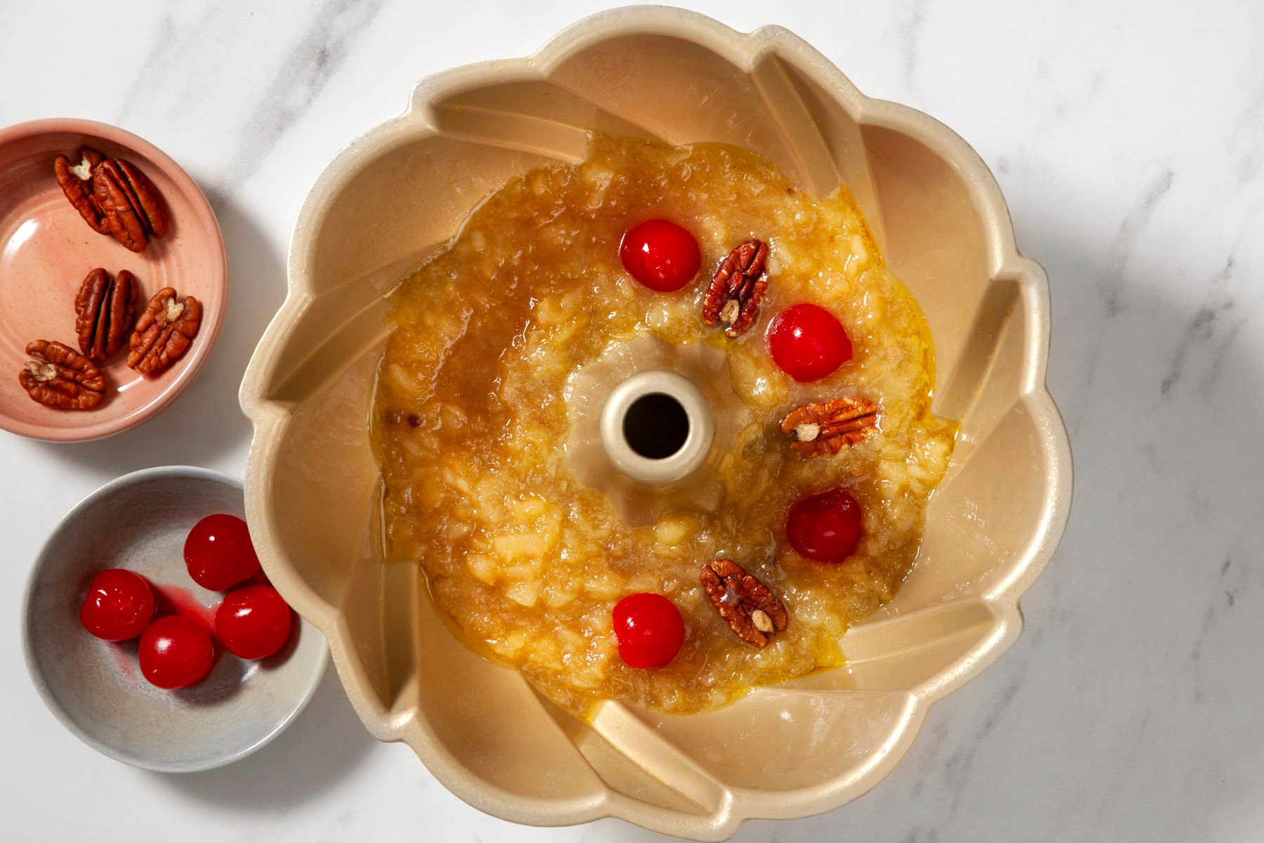 Cherries and pecans added to a mixture of 1/2 cup pineapple, brown sugar, butter and 3 tablespoons pineapple juice.