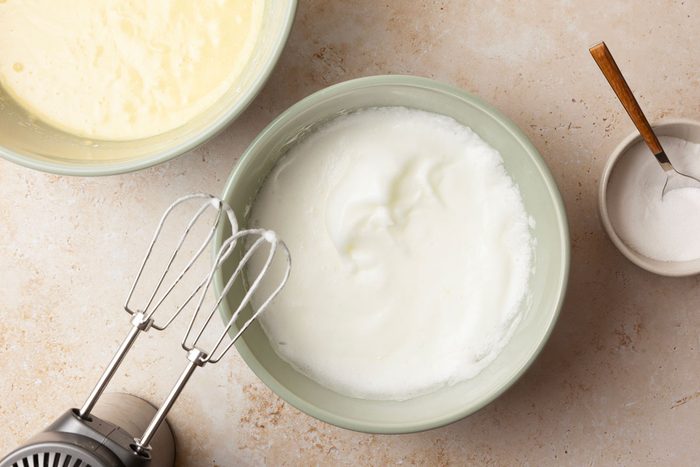 Step 3 of Taste of Home Pineapple Coconut Cake is to beat the egg whites on medium speed until soft peaks form. Gradually add the remaining sugar, 1 tablespoon at a time, beating on high until stiff peaks form. Fold the beaten egg whites into the cake batter.