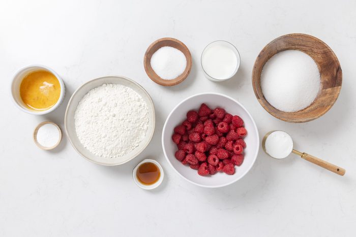 Ingredients for raspberry muffins on kitchen counter.
