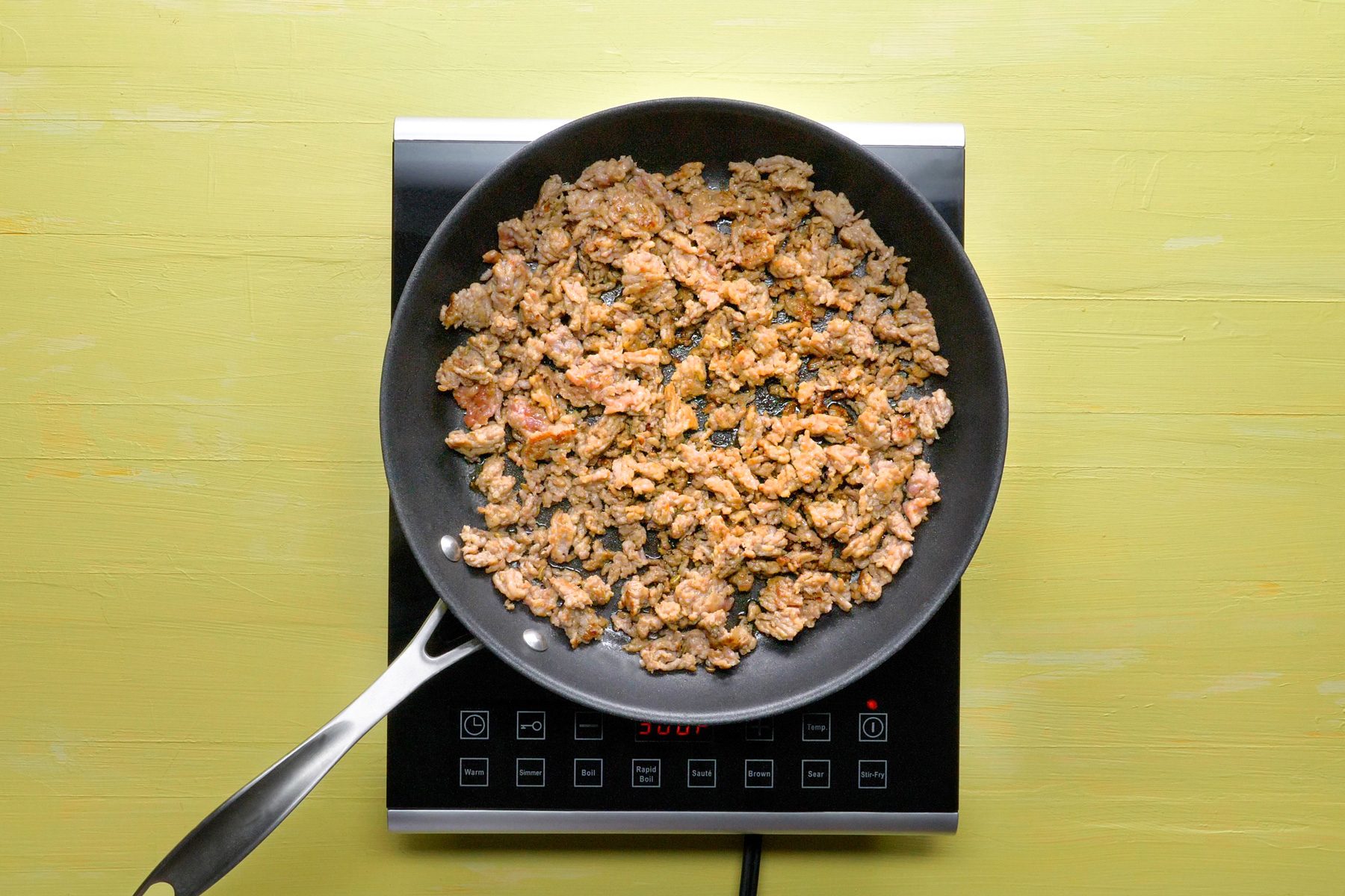 top view shot of cooking the sausage over medium heat