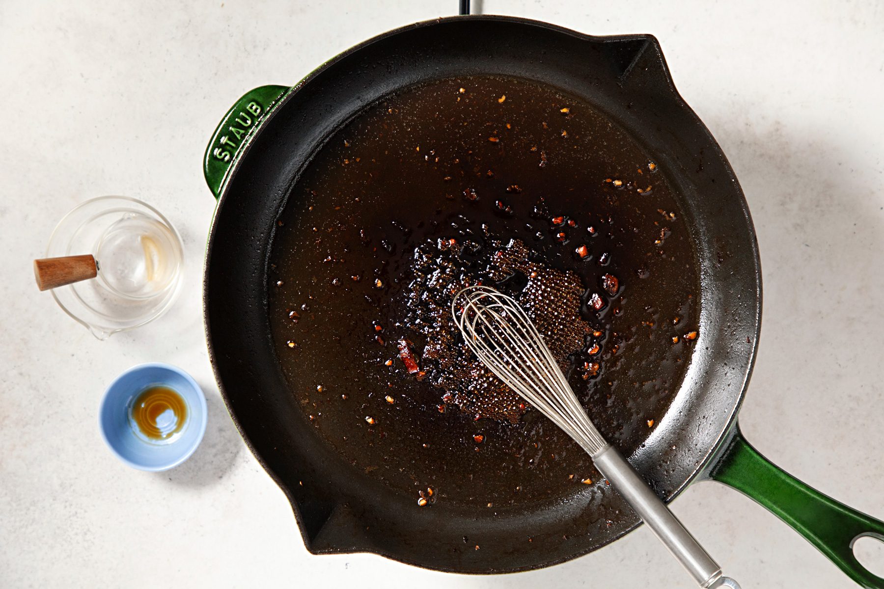 In the same skillet, combine the broth, vinegar and soy sauce; bring to a boil; overhead shot;