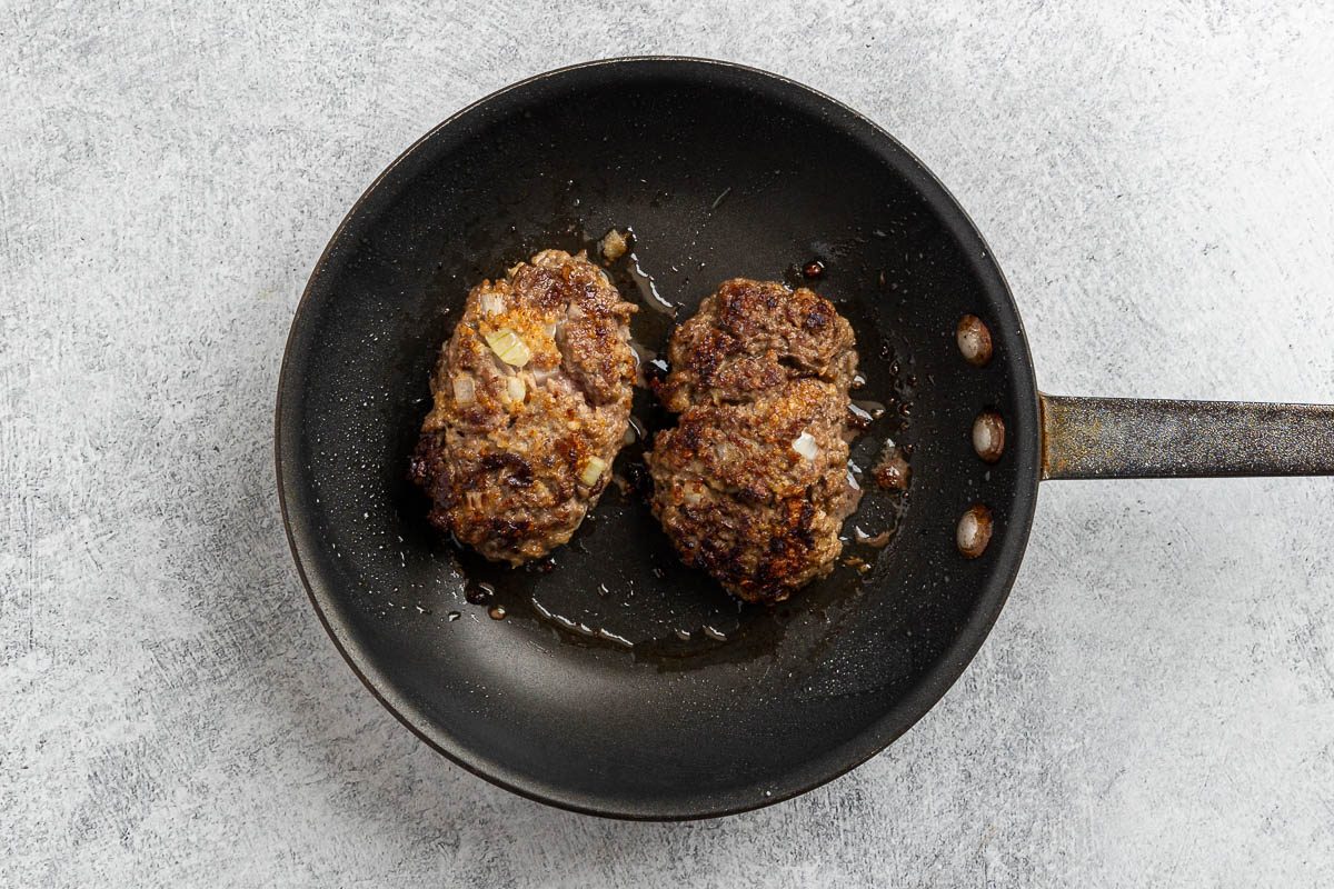 Taste of Home Skillet Meatloaf recipe photo of the ground beef loaves browned in a skillet.