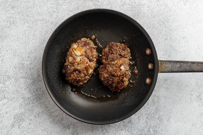 Taste of Home Skillet Meatloaf recipe photo of the ground beef loaves browned in a skillet.
