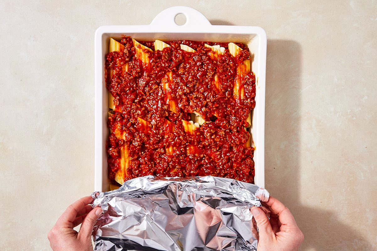 String Cheese Manicotti Step 5- covering 9x13" dish with foil before baking