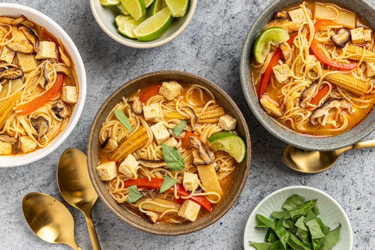 Taste of Home Thai Curry Soup recipe photo of the finished recipe served into bowls garnised with fresh basil and lime.