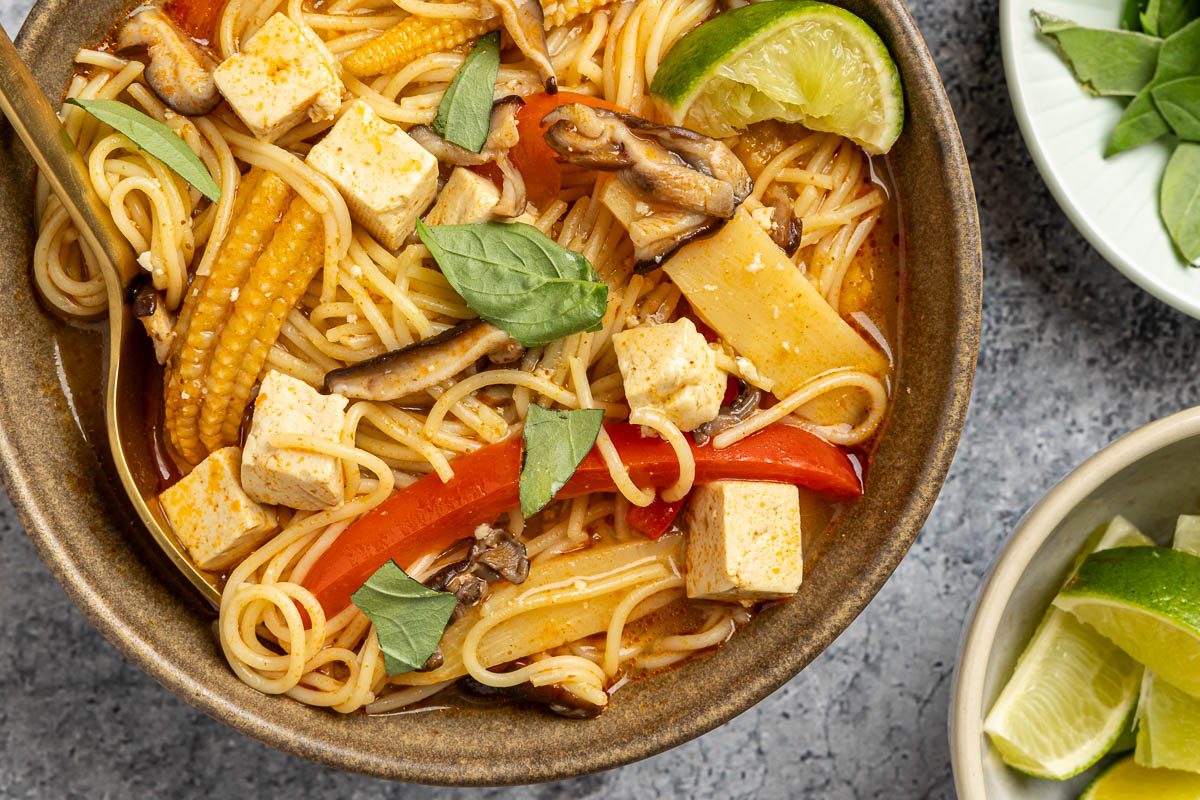 Taste of Home Thai Curry Soup recipe photo of the finished recipe served into bowls garnised with fresh basil and lime.