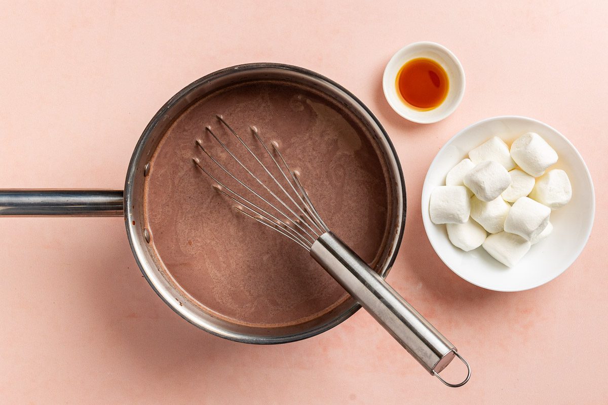 Taste of Home Vegan Hot Chocolate recipe photo of the vanilla extract added to the saucepan.