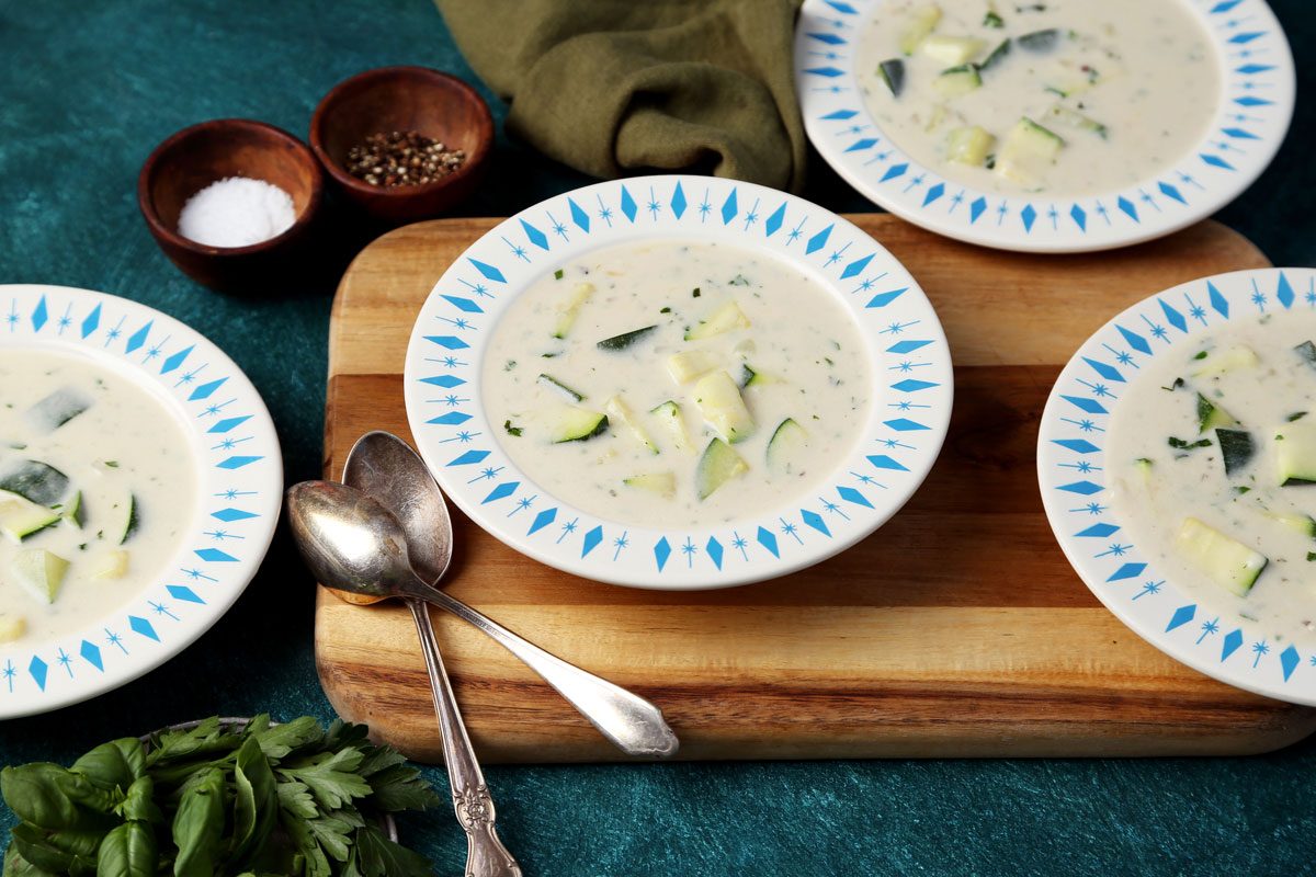 Taste of Home's Zucchini Soup served in bowls with croutons on top.