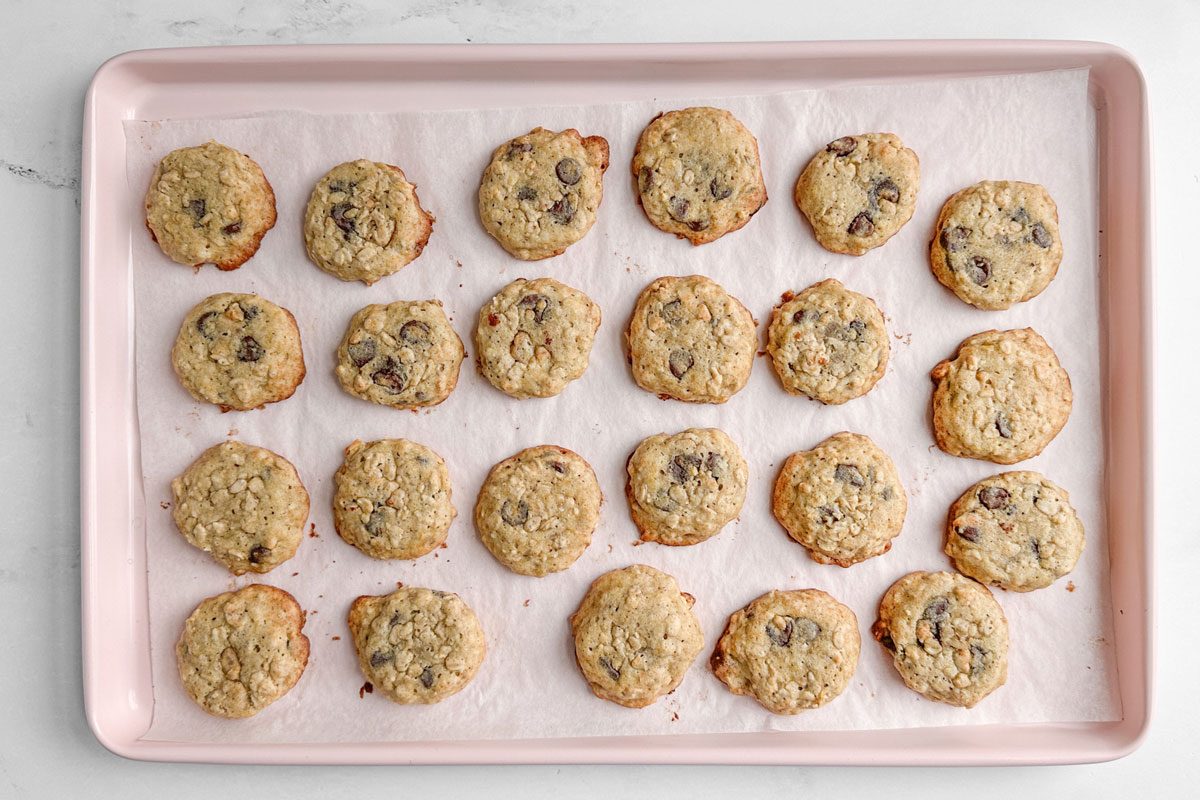 Taste of Home Banana Oatmeal Cookies on a pink baking sheet on a marble surface
