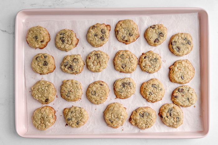 Taste of Home Banana Oatmeal Cookies on a pink baking sheet on a marble surface