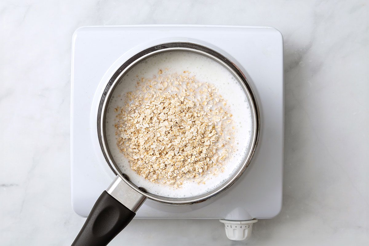 Milk and quick oats in small saucepan on a hot plate