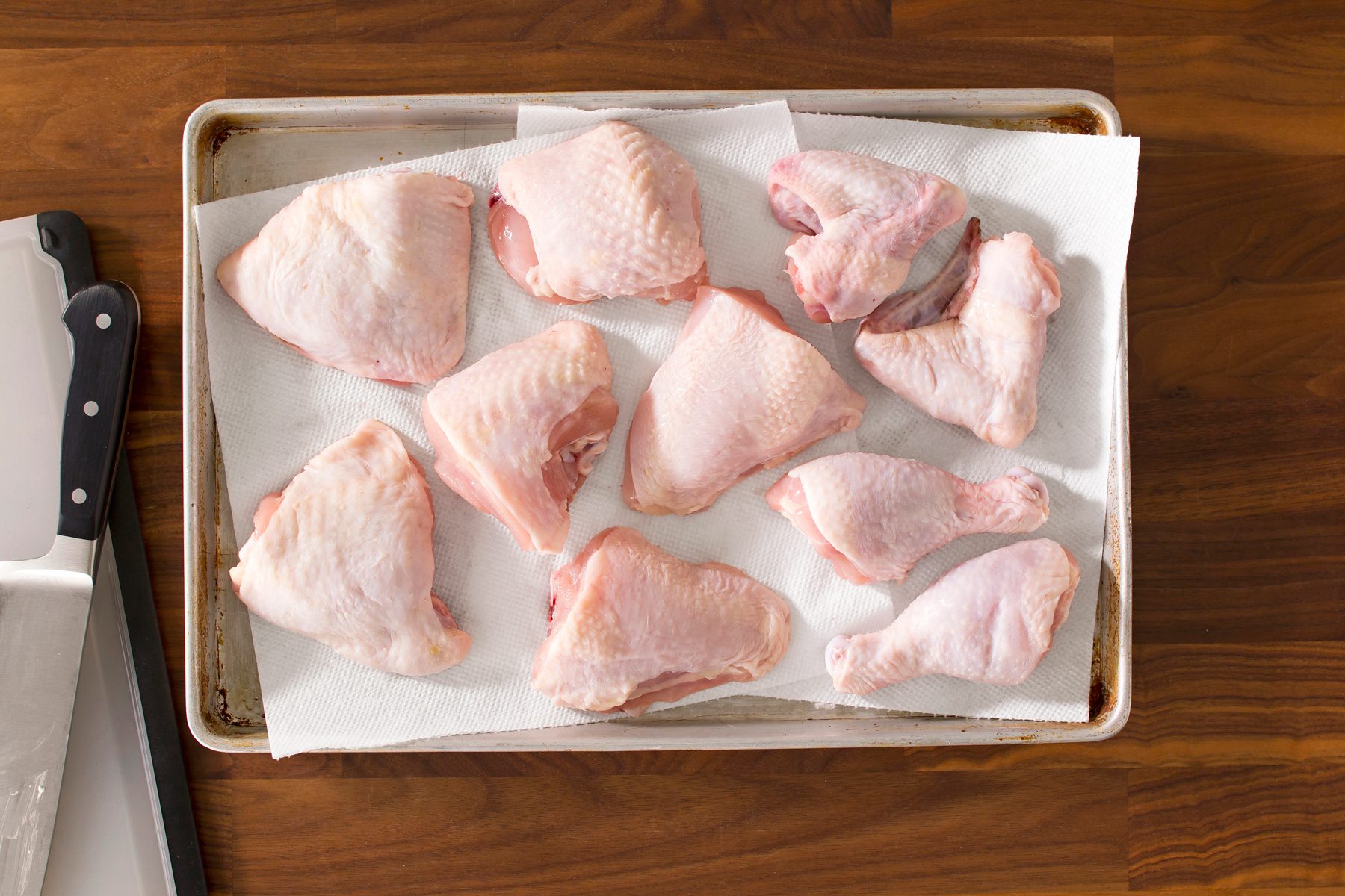 Top view of chicken pieces in a tray on tissue paper