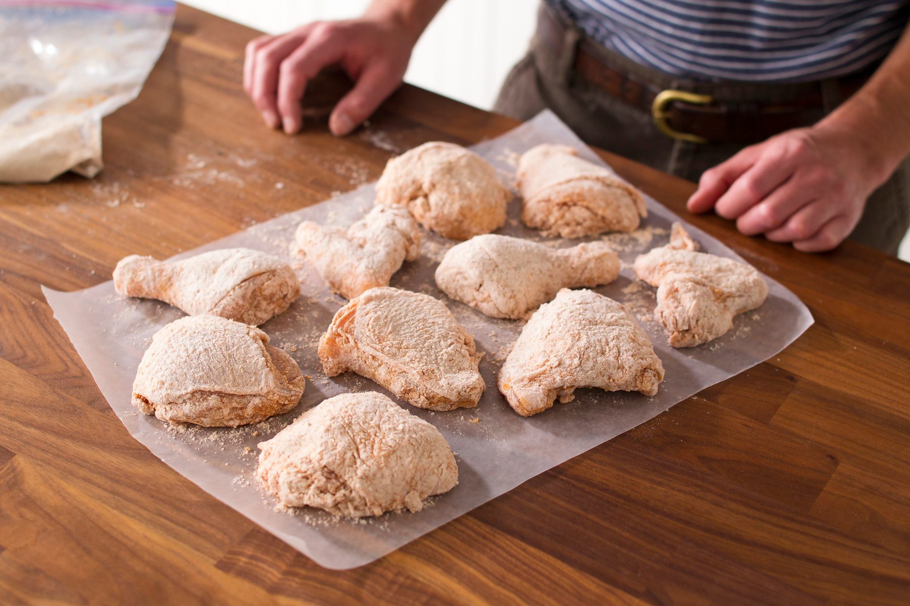 All of the chicken pieces have been coated and placed on the parchment paper and arranged so they are not touching