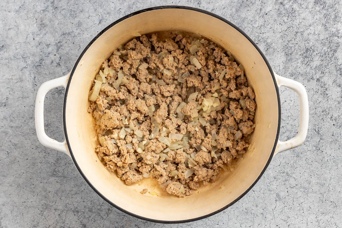 Taste of Home Cabbage Stew recipe photo of the cooked turkey and onion in a Dutch oven.