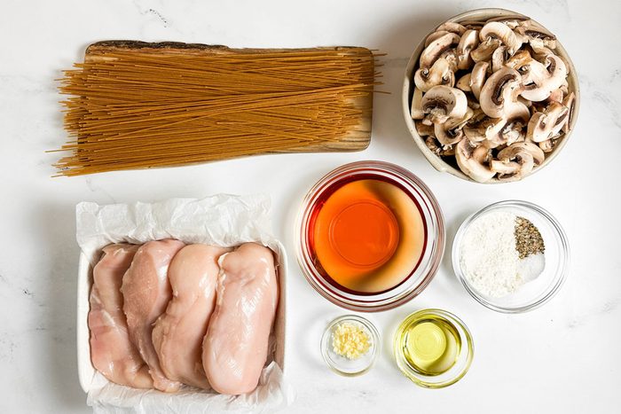 Ingredients for Taste of Home Chicken Marsala on a marble surface