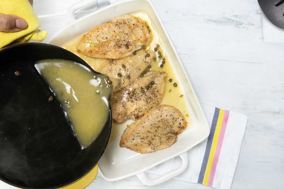 Pouring the sauce on the Chicken