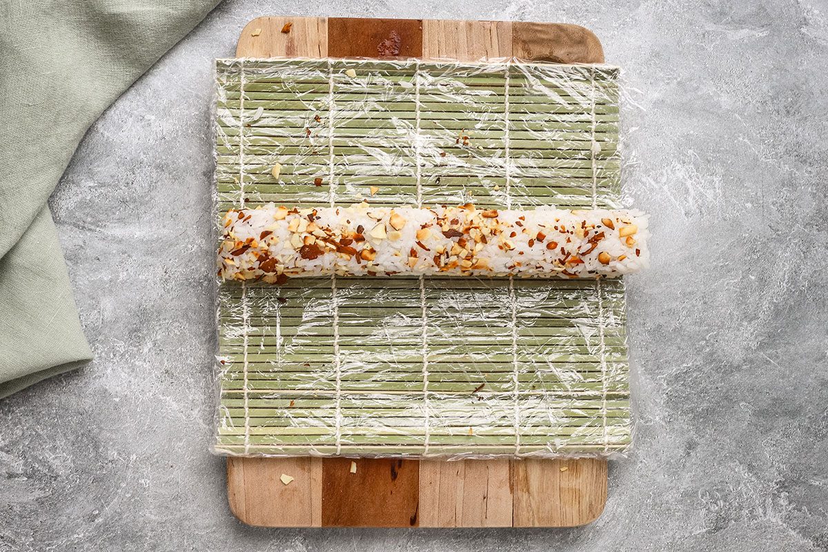Chicken tempura roll shown on sushi mat.