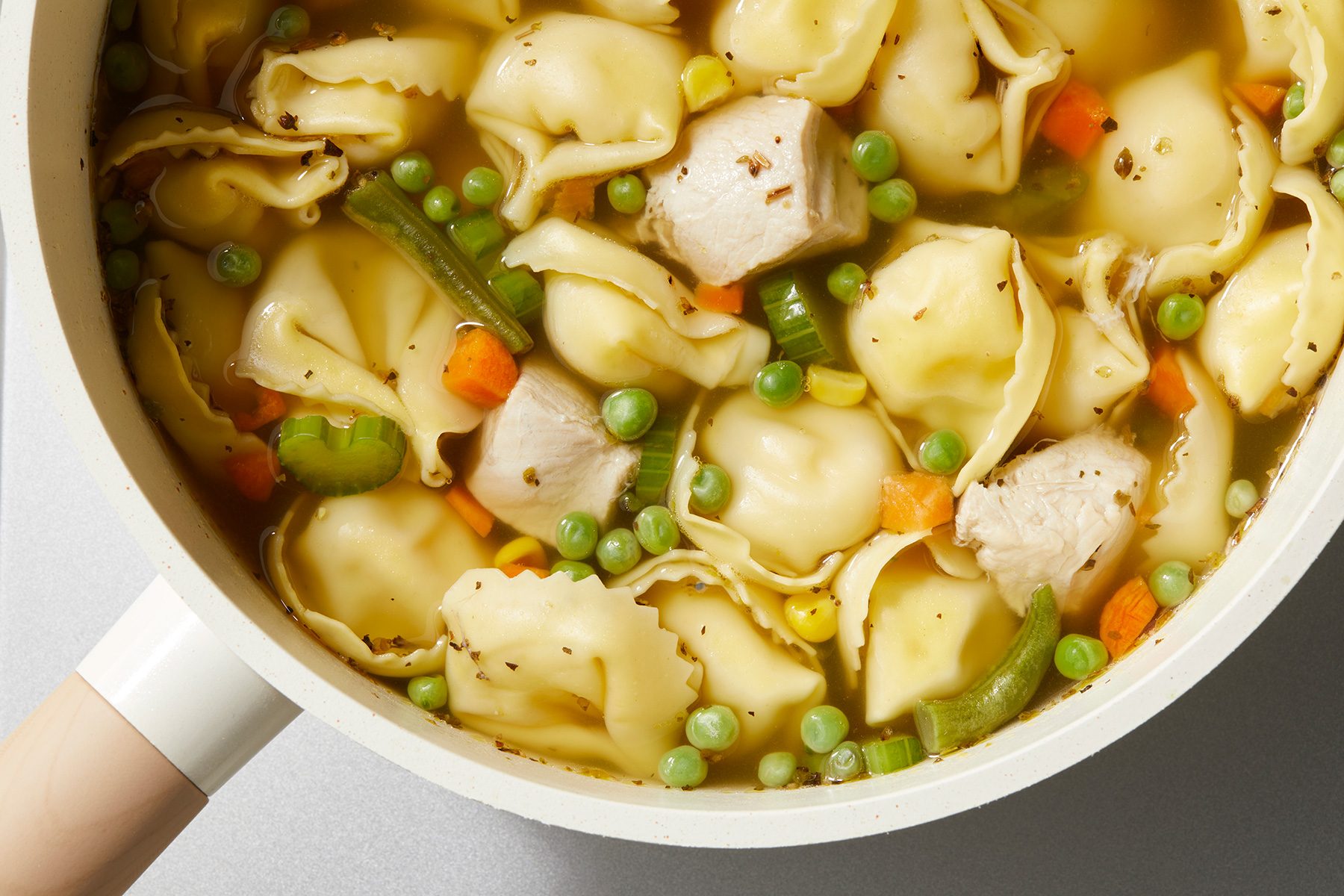 close shot of chicken tortellini soup in a bowl