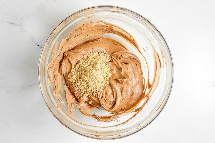 Batter for Taste of Home Chocolate Drop Cookies in a glass bowl on a marble surface