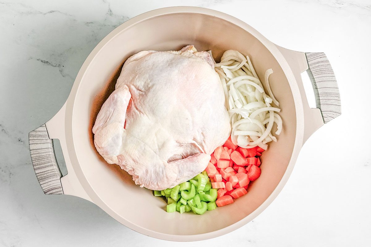 Chicken, carrots, celery and onion for Taste of Home Copycat Cracker Barrel Chicken and Dumplings in a Dutch Oven