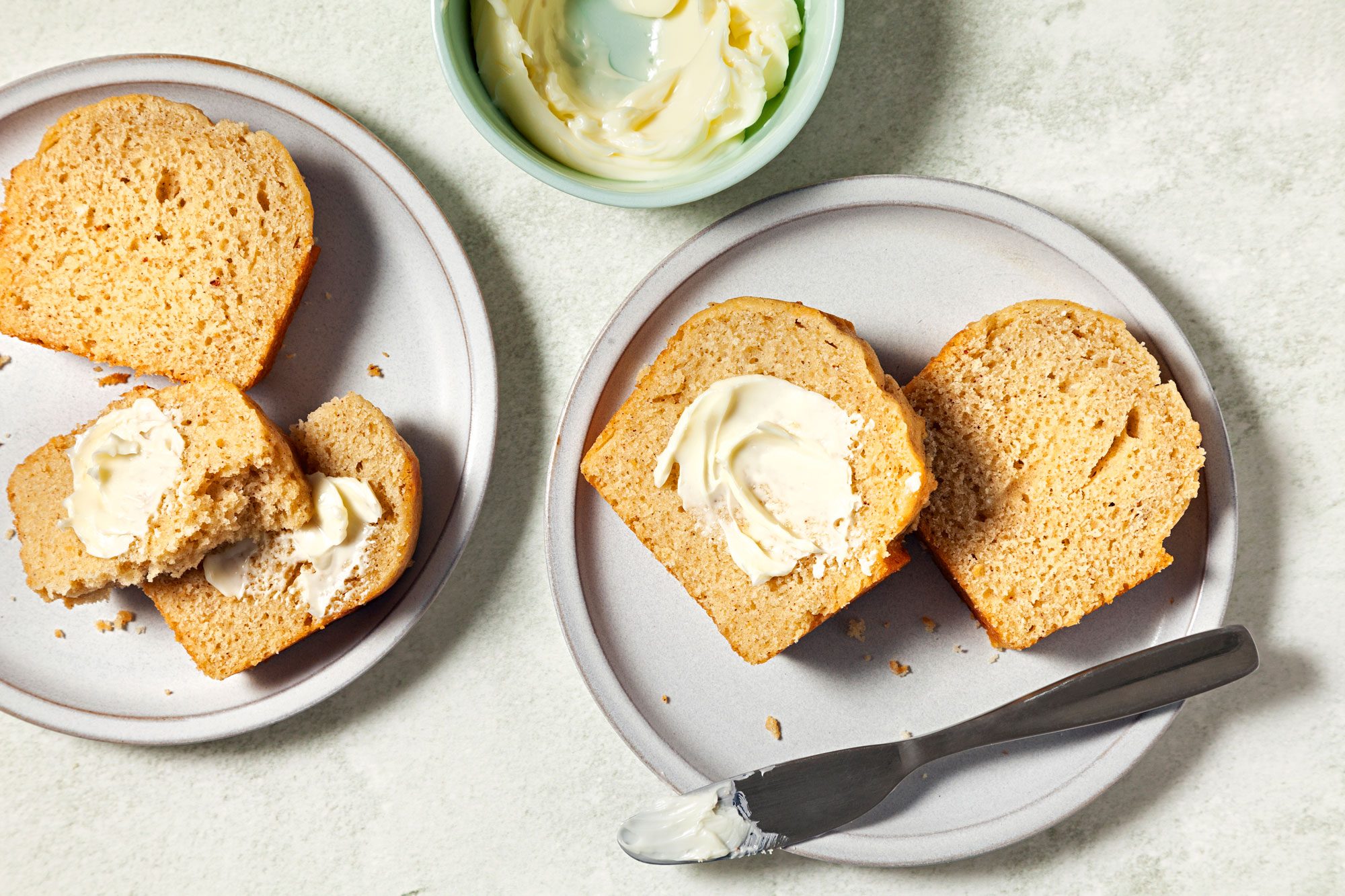 Eggnog Bread served in plates with butter spread over