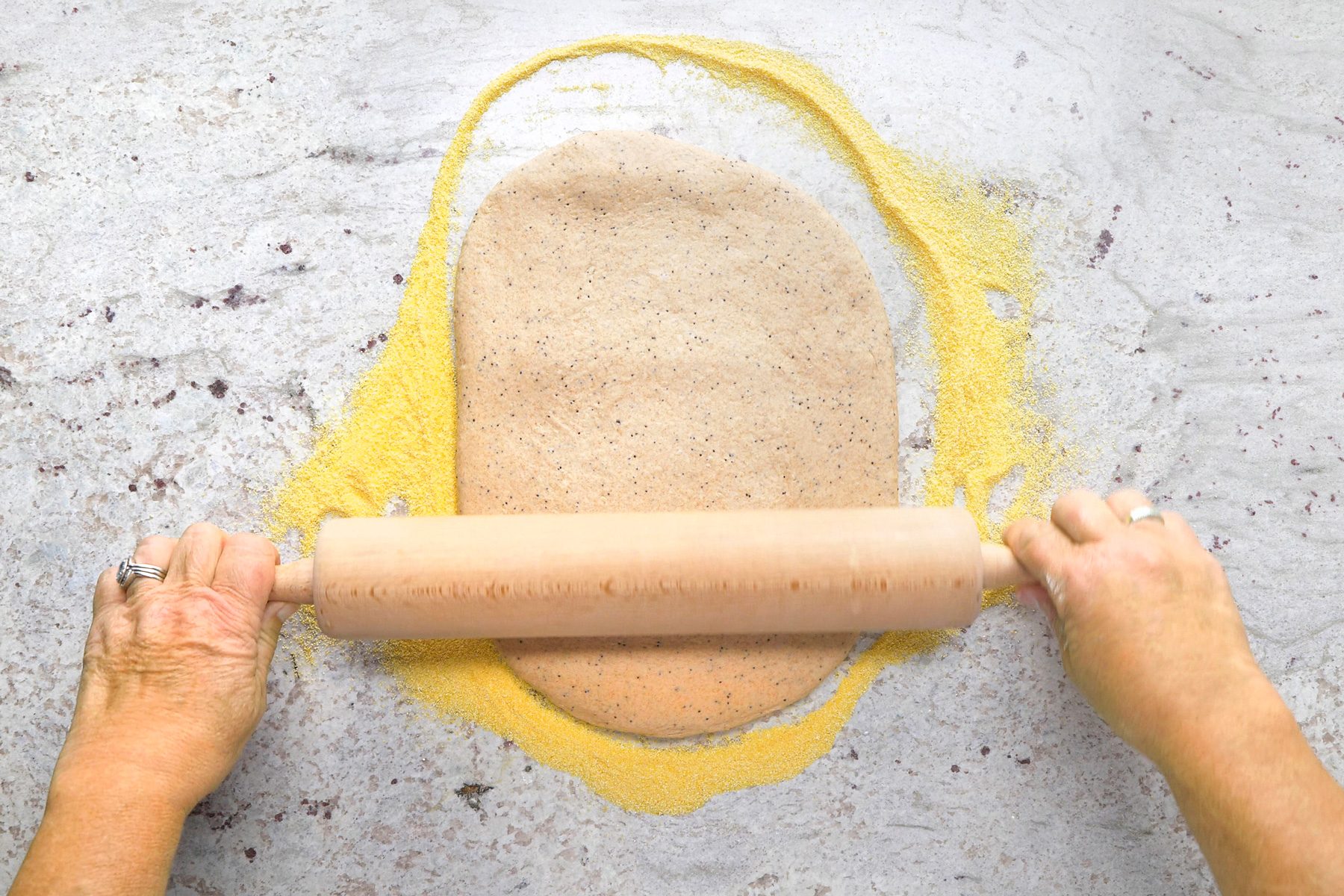 roll the dough on a marble surface with a rolling pin