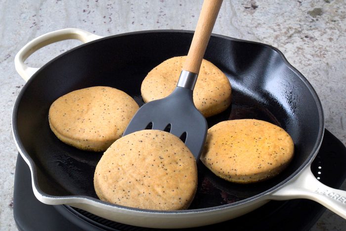 Place muffins, cornmeal side down, in a greased skillet; cook over medium-low heat until bottoms are browned,