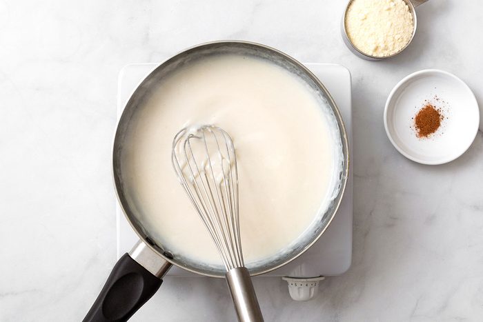 Milk and flour mixture heating in a saucepan on a hot plate for step one of Gnocchi Alfredo recipe for Taste of Home