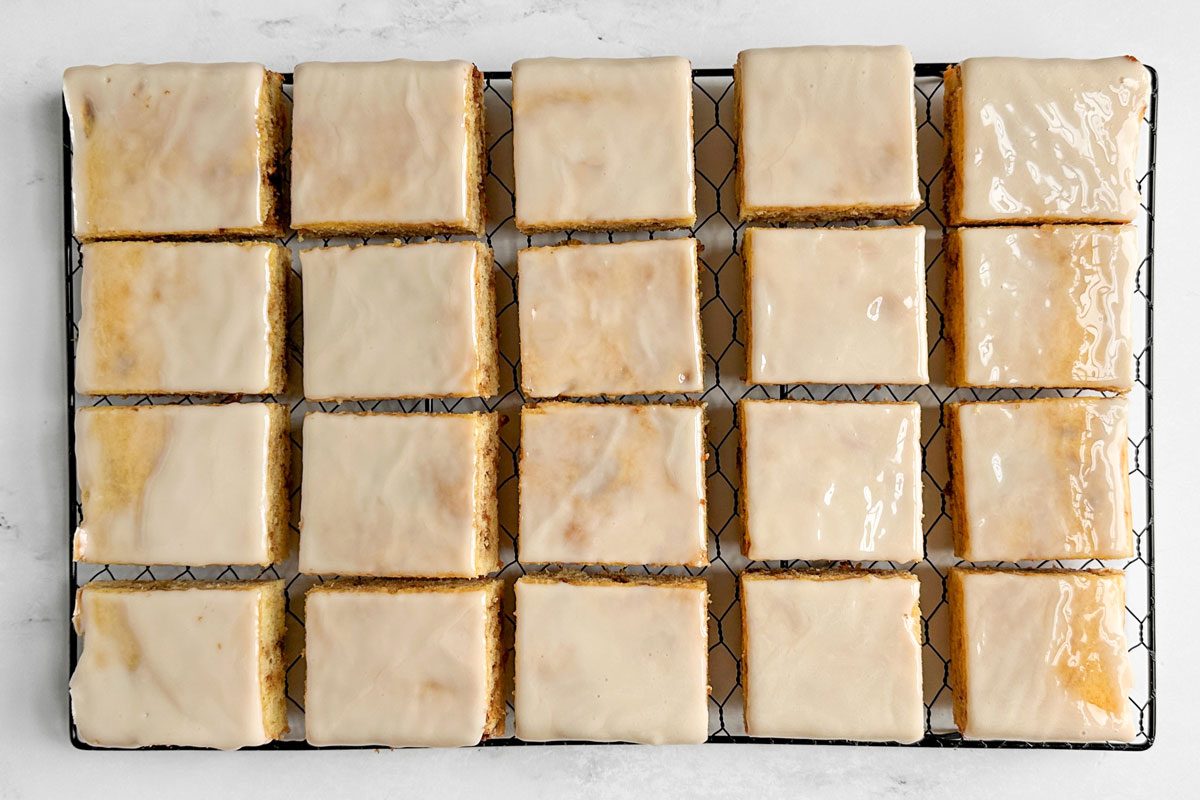 Taste of Home Honey Bun Cake on a wire rack on a marble surface